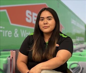 SERVPRO team member in front of new background image