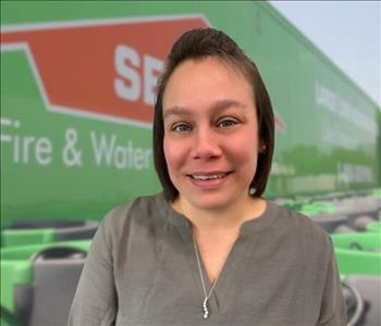 SERVPRO team member in front of new background image