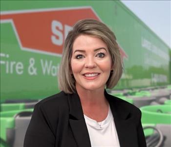 SERVPRO team member in front of new background