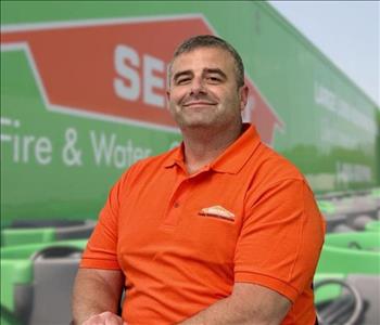 SERVPRO team member in front of new background image