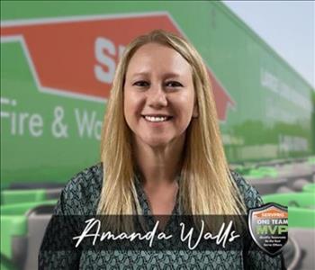 SERVPRO team member in front of new background image