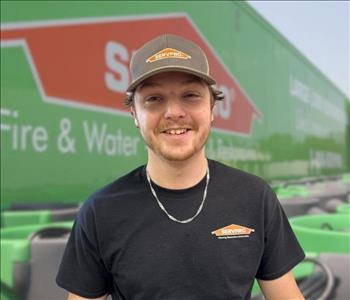 SERVPRO team member in front of new background image