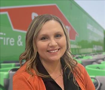 SERVPRO team member in front of new background image